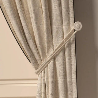 A close-up of the Kantha Pipin curtain tied back, showing its subtle, tone-on-tone Kantha-inspired pattern and the clean piped edge.