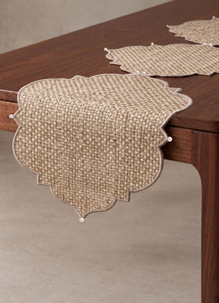 A close-up of two linked medallion segments of the Kasbah Pearl Jute Runner joined by a pearl bead.