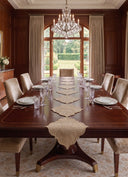 The Kasbah Pearl Jute Runner running the length of a mahogany dining table beneath a crystal chandelier.
