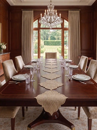 Kasbah Pearl Jute Table Runner displayed on a long mahogany dining table set with crystal stemware and candelabra.