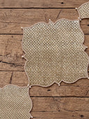 Flatlay view showing Kasbah Pearl placemats and coordinating jute runner layout on a rustic wooden table.