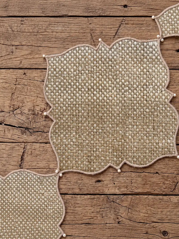 Flatlay view showing Kasbah Pearl placemats and coordinating jute runner layout on a rustic wooden table.