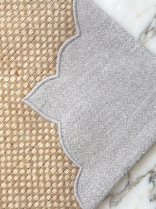 Detailed close-up of Kasbah Pearl placemat highlighting satin stitch embroidery on the scalloped arch corner appliqué