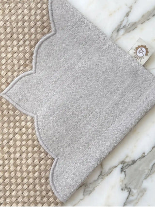 The Kasbah Pearl table runner and matching Dar Alia placemats styled together with crystal glassware on a rustic dark wood table.