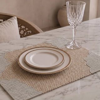 The Kasbah table mat styled with a gold-rimmed plate and crystal wine glass on a marble dining table