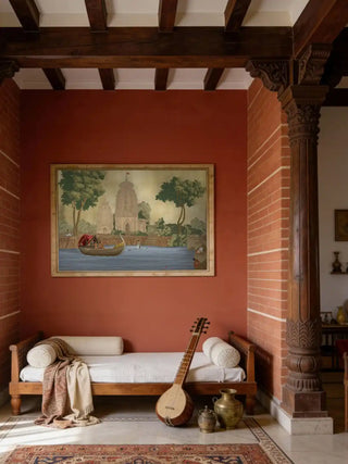 Kashi Reverie wall art framed on a terracotta brick wall above a traditional Indian daybed with a sitar and brass vessels.