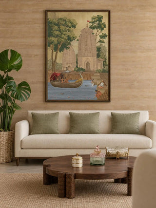 The Kashi Reverie wall art in a dark gilt frame above a cream sofa with sage cushions and a round walnut coffee table.