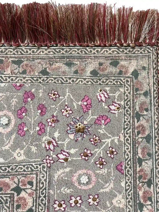 Macro view of the ornate border showing gold sequins, white pearls, and the premium silk fringe texture