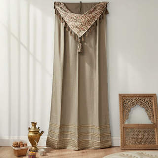 Kashmiriyat Curtain in earthy beige with intricate embroidered valance and tassel accents, styled in a traditional living space.