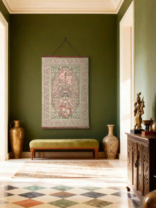Kashmiriyat wall hanging displayed on a deep forest green wall in a luxury hallway with marble floors