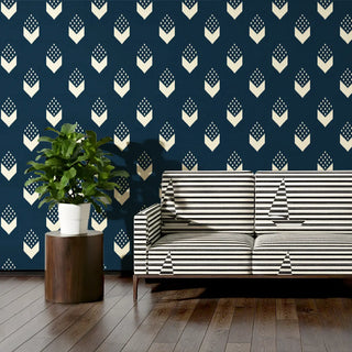 Sofa upholstered in Kashti Fabric styled against a bold navy patterned wall.
