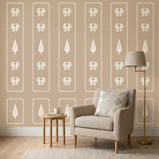 A serene living room setting featuring the Kavya wallpaper behind a beige armchair and a round wooden side table.