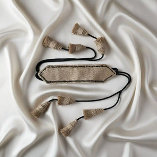 Flat lay of the Kaya Jute Tassel showing the woven geometric central piece and the arrangement of the small natural-fiber tassels.