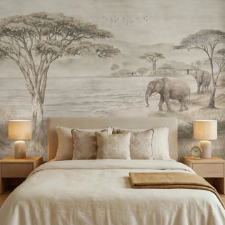 The Kenya Grey African landscape mural styled behind a neutral upholstered bed in a serene, luxury bedroom.
