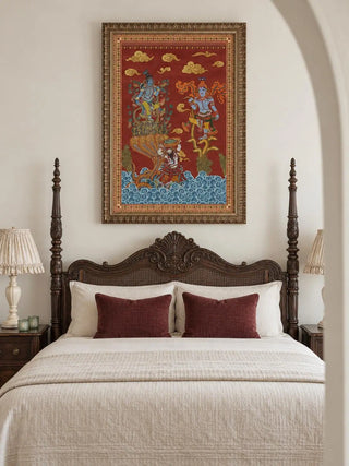 Keshava portrait wall art in an ornate bronze-toned frame above a dark wood four-poster bed with a carved headboard, cream bedding and two maroon cushions.