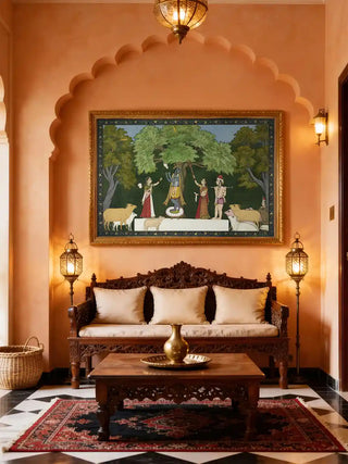 Krishna Leela with Gopis wall art in deep green, framed in gold beneath a scalloped arch above a carved wooden daybed with cream cushions and brass lanterns in a living room.