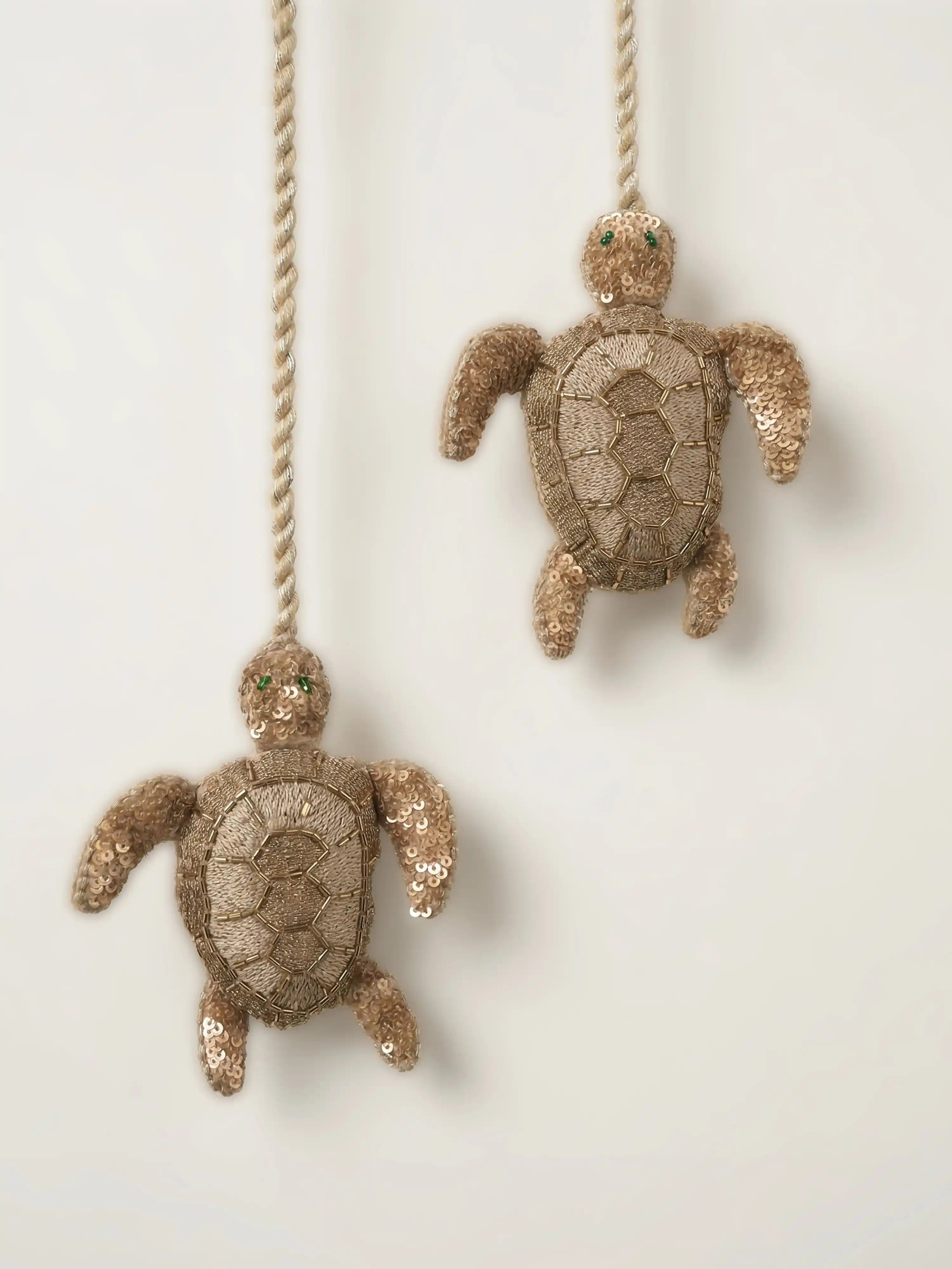 Kurma Zardozi tieback holding back cream linen curtains in a luxury sun-drenched room