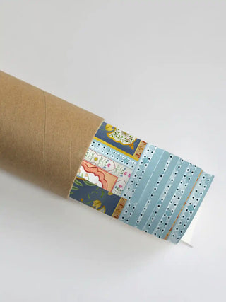 A close-up of the Delli Darbar mural showing the blue floral border as it is unrolled from a premium shipping tube.