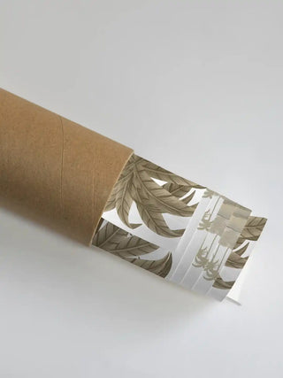 Close-up of the Jaisalmer wall art partially unrolled from its rigid shipping tube, showcasing the palm tree details and warm beige tones.