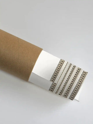 A close-up of the Safar artwork showing the architectural border as it is unrolled from a premium shipping tube.