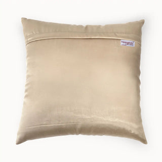 Back view of Rocaille Charm cushion showing solid champagne fabric and brand tag