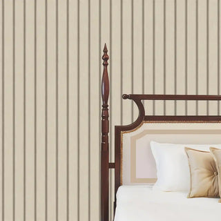 A detailed close-up of the Linear Harmony wallpaper highlighting the alternating charcoal and grey pinstripe widths beside a carved wood bedpost