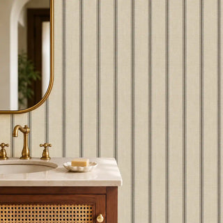 The Linear Harmony beige black wallpaper installed above a marble vanity with brass fixtures and a gold-framed mirror in a powder room view-powder
