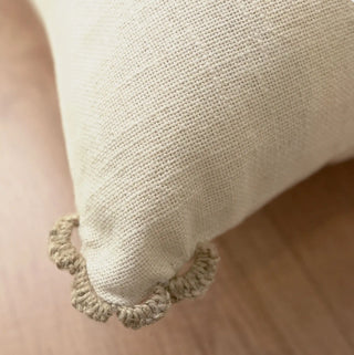 A high-resolution close-up of the hand-guided taupe blanket stitching and open-mesh panel on the Linen Poet cushion cover.