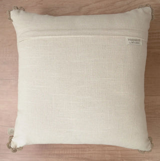 The reverse side view of the Linen Poet cushion cover showing the clean fabric backing, hidden zipper closure, and brand woven tag.
