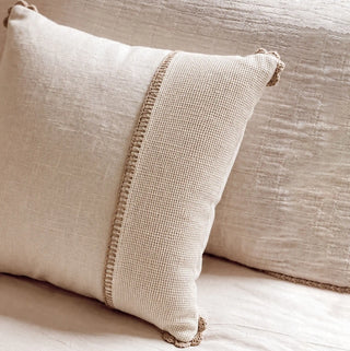 A side-angle view of the square Linen Poet cushion cover showcasing its rich textile boundaries and ivory tones.