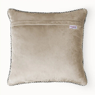 The reverse side of the Diamond Weave beige velvet cushion showing the hidden zipper and brand tag.