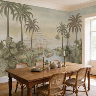 A formal dining room featuring the Island of Sanctuary mural behind a wooden table and rattan chairs.