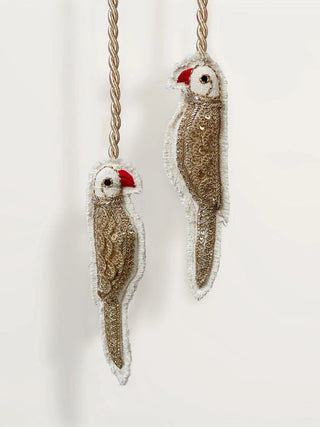 Ranjha Parrot curtain tieback featuring gold braided cord and handcrafted embroidered birds.