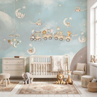 A luxury nursery featuring the Cuddly Express mural behind a white crib with plush animal toys and a celestial mobile.