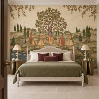 The Madhav Madhuban wallpaper mural behind a cane-headboard bed with an olive throw, Krishna and gopis beneath a flowering tree view-bedroom
