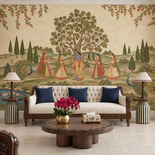 The Madhav Madhuban wallpaper mural with Krishna and gopis behind a carved sofa with navy cushions and a round wooden coffee table view-livingroom