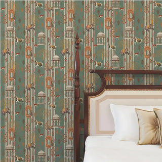 The Majestic Mewar green wallpaper installed behind a carved wood four-poster bed frame with tan and cream cushions
