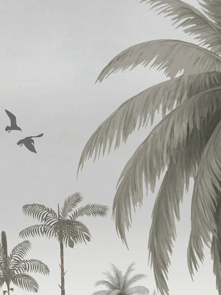 A close-up of The Malabar Wall Art in Mist-Grey showing coconut palms and two birds in flight against a soft grey sky.