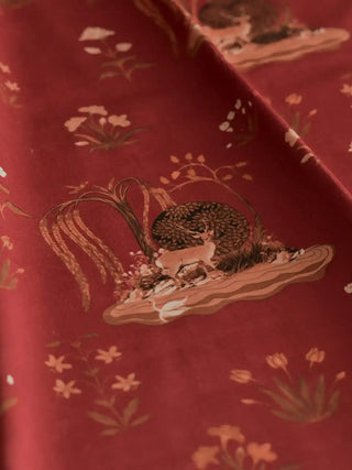 A close up detail of the Malhar fabric showcasing the spotted deer and weeping willow brushstrokes.