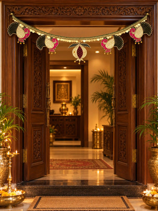 The Mangal Mayura bandhanwar across a carved wooden doorway, four velvet peacocks and a central anar hanging from a gold coin fringe.