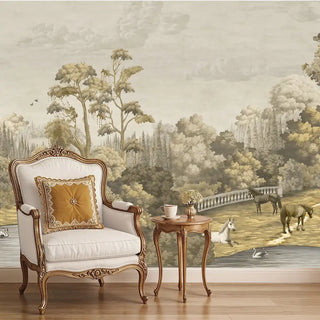 A sepia-toned European vintage wallpaper depicting a manor estate scene with trees, a bridge, and horses, applied to a wall behind a classic armchair and side table.
