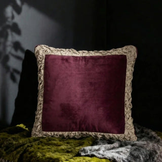The Jhalak maroon cushion styled in a moody, dark-toned interior setting for a luxury look.
