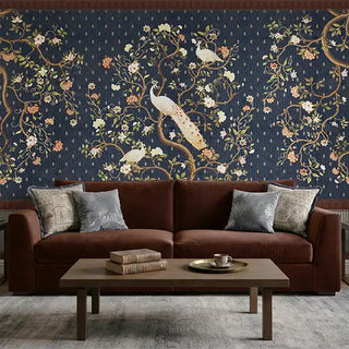 A luxury living room featuring the Mayura Blue mural behind a chocolate brown velvet sofa and contemporary decor.