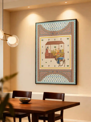 Meena Bazar wall art in ivory and terracotta, framed in slim black above a walnut dining table with a brass bowl and glass globe pendant lights.