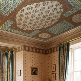 Full room view of Meena Jaal ceiling mural in terracotta and teal applied overhead in a classical interior with coordinating blush scattered-butti wallpaper on the walls, an oval lattice cornice frieze, teal silk curtains on gold rods, and framed artworks