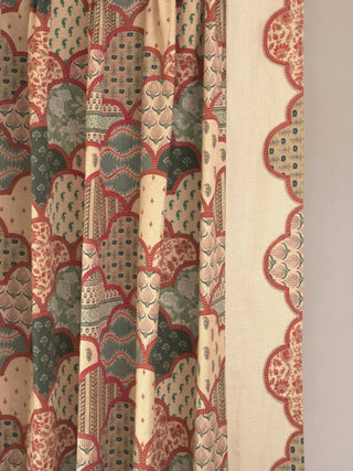 A detailed view of the Mehr curtain panel showing the transition between the solid oatmeal linen and the intricate printed leading edge.