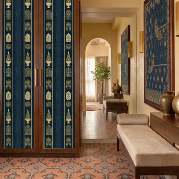 Mehrab Stripes wallpaper in royal blue and gold applied across wardrobe panels in a heritage-style foyer with walnut cabinetry, terracotta encaustic floor tiles, brass wall sconces, and a cream upholstered bench