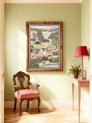 Luxury wall art featuring the Mewar royal procession displayed in a sage green foyer with a vintage pink velvet chair.