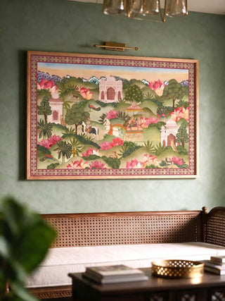 The Mewar Indian wall art in Green & Brown, framed and hung view-livingroom above a cane-back daybed.