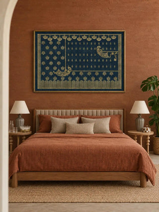 Framed Midnight Crest navy and gold wall art above a wooden bed with rust bedding and linen cushions against a terracotta wall in a bedroom